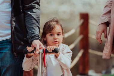 Family time in the park. Father have fun with his daughter in the park, playing fun games and spending time together. 