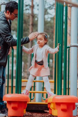 Family time in the park. Father have fun with his daughter in the park, playing fun games and spending time together. 
