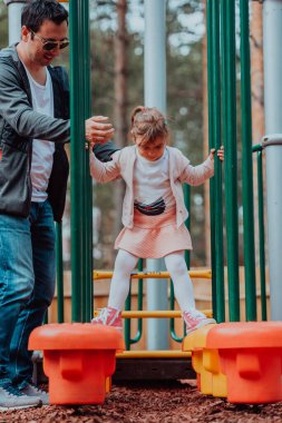Family time in the park. Father have fun with his daughter in the park, playing fun games and spending time together. 