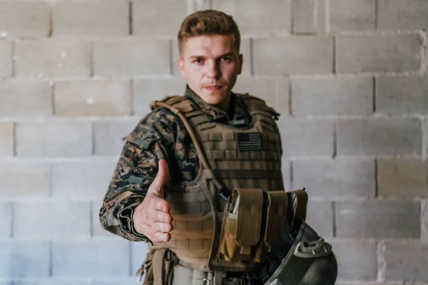 Żołnierz Mundurze Stoi Przed Kamienną Ścianą Wyciągniętą Ręką Koncepcja Partnerstwa — Zdjęcie stockowe
