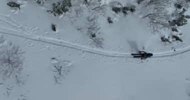 Kışın taze kar mevsiminde dağlarda kameranın önünden geçen hava kayaklı adam. Deri yokuşunda bir sıra halinde kayak turu. Toz günü. kayak tatili konsepti. Yüksek kalite 4k