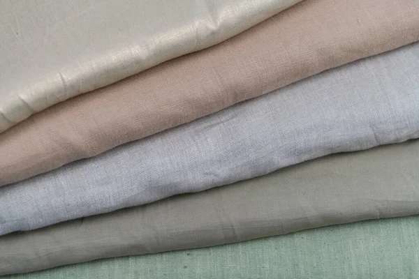 Collection of fashionable fabrics. Samples of different natural fabrics for sewing a fashion collection of clothes. Large selection of fabrics in the store or tailor warehouse. High quality photo