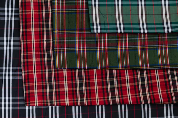 stock image Collection of Scottish fashionable fabrics . Samples of different natural fabrics for sewing a fashion collection of clothes. Large selection of fabrics in the store or tailor warehouse. High quality