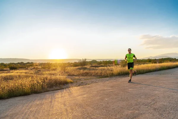 stock image Triathlete in professional gear running early in the morning, preparing for a marathon, dedication to sport and readiness to take on the challenges of a marathon