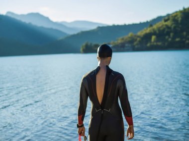 Bir triatlon yüzücüsü maratona hazırlanmak için nehir eğitimine hazırlanıyor. Yüksek kalite fotoğraf