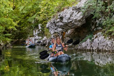 Bir grup arkadaş, sakin nehri, ormanı ve büyük doğal nehir kanyonlarını keşfederken eğleniyor ve kayak yapıyor.. 