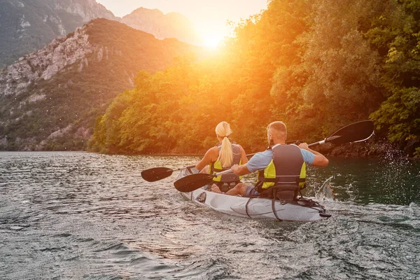 一群朋友在田园诗般的夕阳西下 在平静的河流 森林和大河大峡谷中畅游 享受着欢乐和划艇的乐趣 — 图库照片