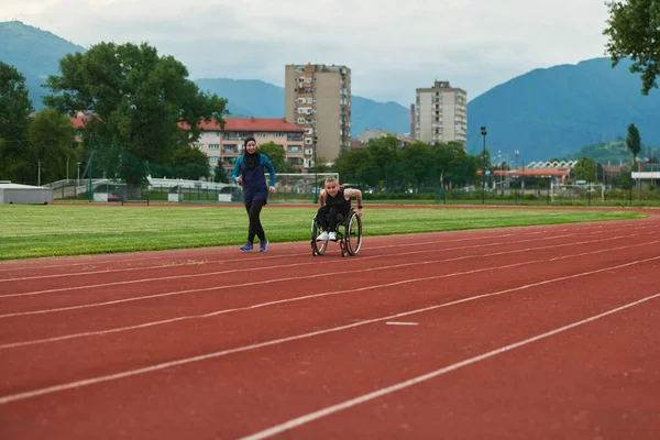 Çarşaflı Müslüman Bir Kadın Maraton Kursunda Tekerlekli Sandalyeli Bir Kadınla — Stok fotoğraf