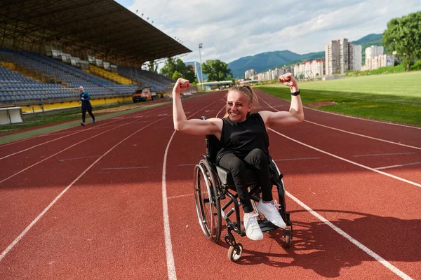 휠체어를 장애가 여자가 자신의 근육을 보여줌으로써 나타낸다 — 스톡 사진