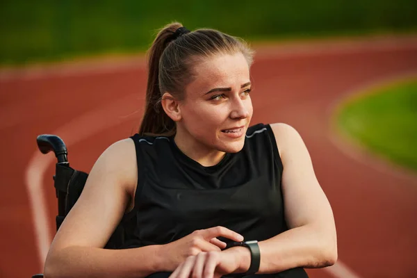 stock image A woman with disability in a wheelchair checking a smart watch after a quick workout. High quality photo