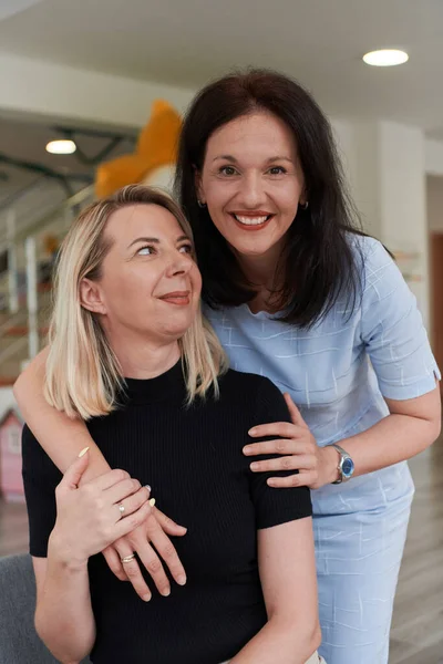 Duas Mulheres Compartilham Abraço Sincero Enquanto Estão Uma Pré Escola — Fotografia de Stock