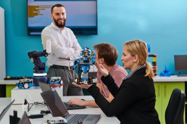 Robot laboratuvarında birlikte çalışan bir grup iş arkadaşı, robotik ve 3D yazıcıların karmaşık alanlarına odaklanıyor. Araştırmalarında yeniliğe olan adanmışlıklarını gösterirler.