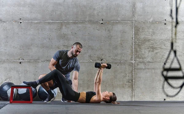 Muskulös Man Som Hjälper Vältränad Kvinna Ett Modernt Gym När — Stockfoto