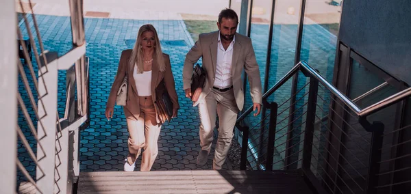 Stock image Modern business couple after a long days work, walking together towards the comfort of their home, embodying the perfect blend of professional success and personal contentment