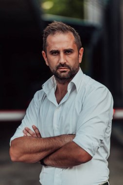 Beyaz gömlekli başarılı bir iş adamı dışarıda poz veriyor. Yüksek kalite fotoğraf