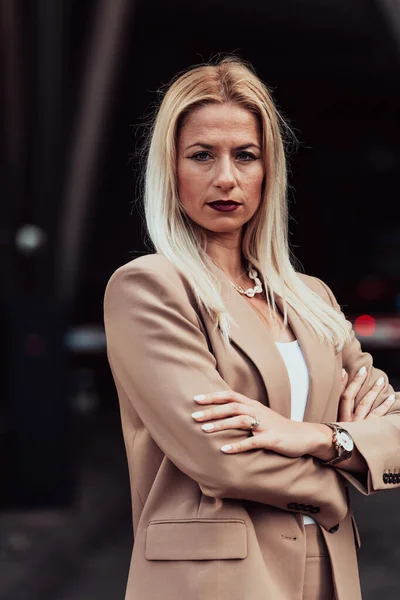 A powerful portrait of a businesswoman, standing confidently with her arms crossed, representing the determination of the female gender and embodying strength and success.