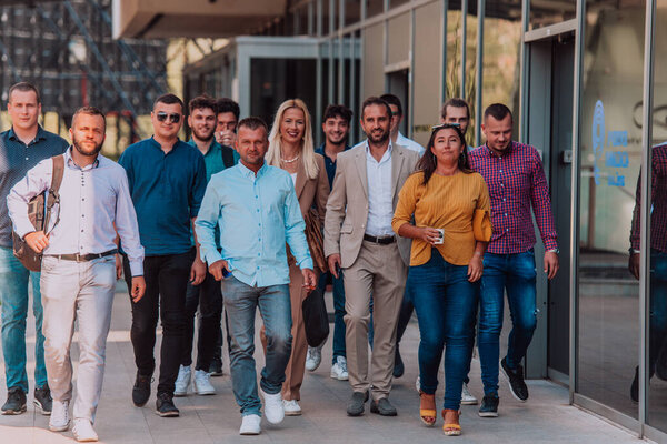 A diverse group of businessmen and colleagues walking together by their workplace, showcasing collaboration and teamwork in the company