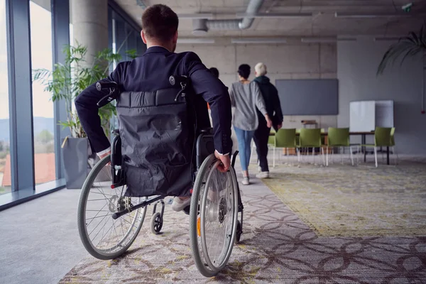 A diverse group of business professionals, including an person with a disability, gathered at a modern office for a productive and inclusive meeting