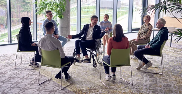 Businessman Wheelchair Center Circle Passionately Sharing His Business Ideas His — Stock Photo, Image