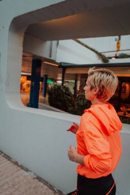 Women in sports clothes running in a modern urban environment. The concept of a sporty and healthy lifestyle. 