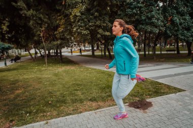 Women in sports clothes running in a modern urban environment. The concept of a sporty and healthy lifestyle. 