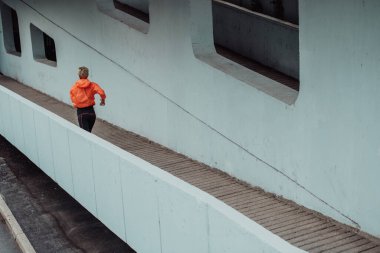 Women in sports clothes running in a modern urban environment. The concept of a sporty and healthy lifestyle. 