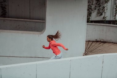 Women in sports clothes running in a modern urban environment. The concept of a sporty and healthy lifestyle. 