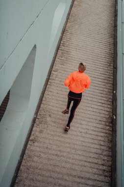 Top view photo of omen in sports clothes running in a modern urban environment. The concept of a sporty and healthy lifestyle. 