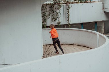 Women in sports clothes running in a modern urban environment. The concept of a sporty and healthy lifestyle. 