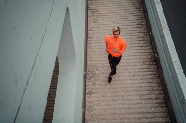 Top view photo of omen in sports clothes running in a modern urban environment. The concept of a sporty and healthy lifestyle. 