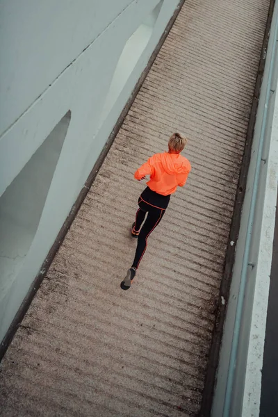 Top view photo of omen in sports clothes running in a modern urban environment. The concept of a sporty and healthy lifestyle.