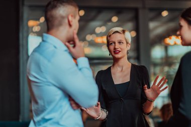 Photo of a business team of young people discussing business ideas in a modern urban environment. Selective focus.