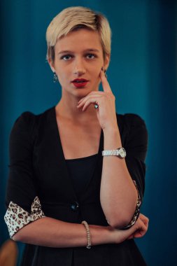 Blonde business woman, successful confidence on modern blue mat background. Selective focus. 