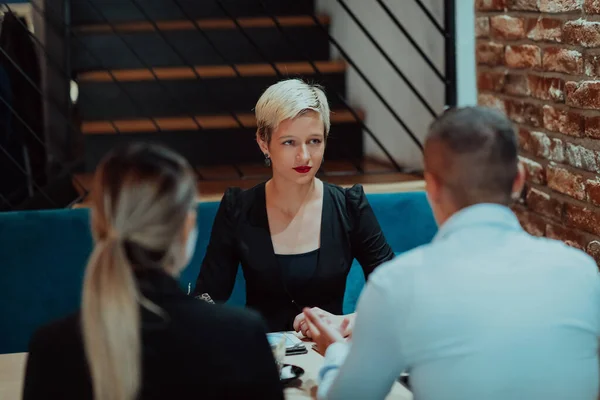 stock image Happy businesspeople smiling cheerfully during a meeting in a coffee shop. Group of successful business professionals working as a team in a multicultural workplace. 