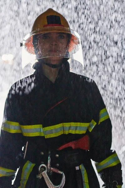 Μια Αποφασισμένη Γυναίκα Πυροσβέστης Επαγγελματική Στολή Διασχίζει Την Επικίνδυνη Βροχερή — Φωτογραφία Αρχείου
