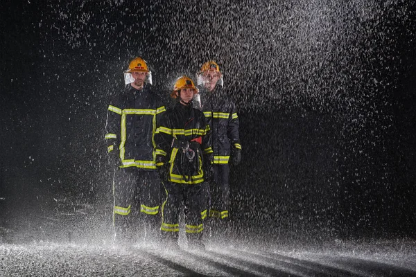 Group Professional Firefighters Marching Rainy Night Rescue Mission Determined Strides — Stock Photo, Image