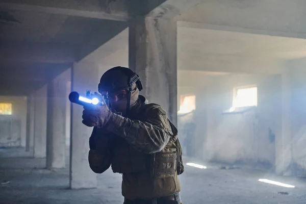 A professional soldier in an abandoned building shows courage and determination in a war campaign.