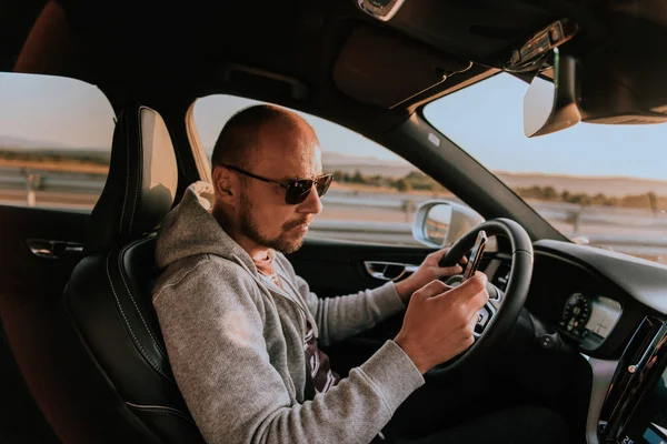 Een Man Met Een Zonnebril Rijdt Een Auto Typt Een — Stockfoto