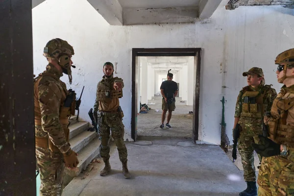 Grupa Żołnierzy Omawia Taktykę Wojskową Znajdując Się Opuszczonym Budynku Skrupulatnie — Zdjęcie stockowe