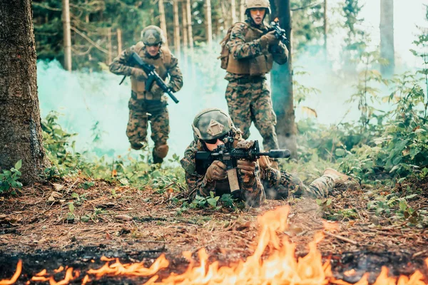Modern warfare soldiers surrounded by fire fight in dense and dangerous forest areas.