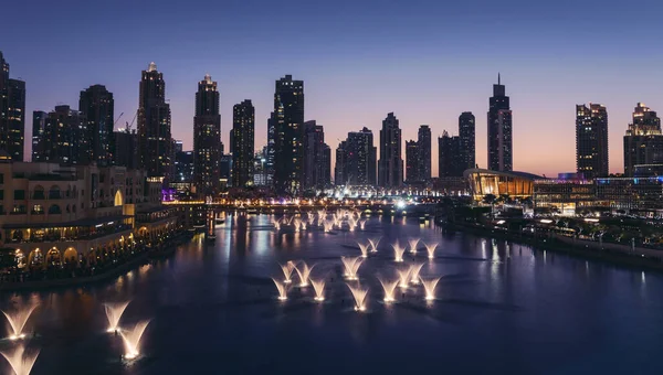 Unique view of Dubai Dancing Fountain show at night. Tourist attraction. Luxury travel destination in charming and beautiful middle east.