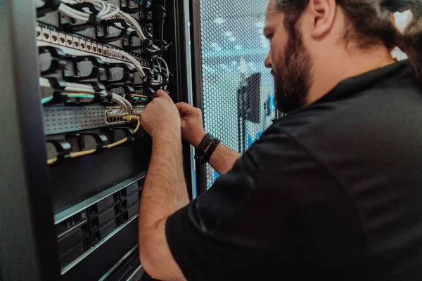 Close up of technician setting up network in server room .
