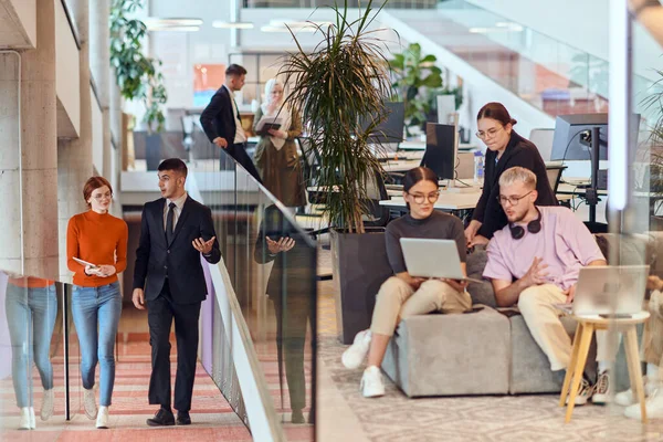 stock image In a modern startup office, a diverse group of young professionals collaboratively tackles various business problems and challenges, surrounded by their engaged colleagues, fostering innovation and