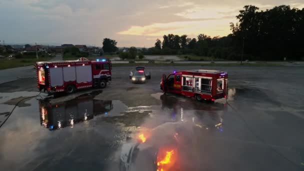 Съемка Беспилотника Группы Профессиональных Пожарных Работающих Вместе Потушить Пожар Машине — стоковое видео