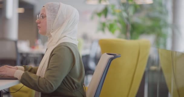 Деловая Женщина Хиджабе Работает Компьютером Современном Офисе Подчеркивая Инклюзивность Профессионализм — стоковое видео