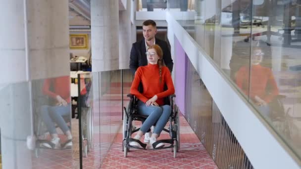 Company Director Assists His Business Colleague Wheelchair Helping Her Navigate — Stock Video