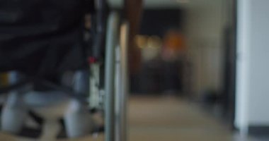 Bulanık kavramsal video, tekerlekli sandalyeler, yaratıcı fikirler geliştirmek ve çözümler bulmak için çeşitli profesyonellerin işbirliği yaptığı modern bir başlangıç ofisinde kapsayıcılığı ve erişilebilirliği simgeler.