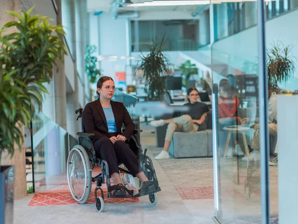 In a modern office, a young businesswoman in a wheelchair is surrounded by her supportive colleagues, embodying the spirit of inclusivity and diversity in the workplace.