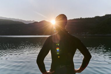 Otantik triatlon atleti gölde yüzme antrenmanına hazırlanıyor. Yüksek kalite fotoğraf