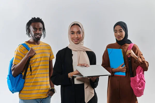 A group of students, including an African American student and two hijab-wearing women, stand united against a pristine white background, symbolizing a harmonious blend of cultures and backgrounds in